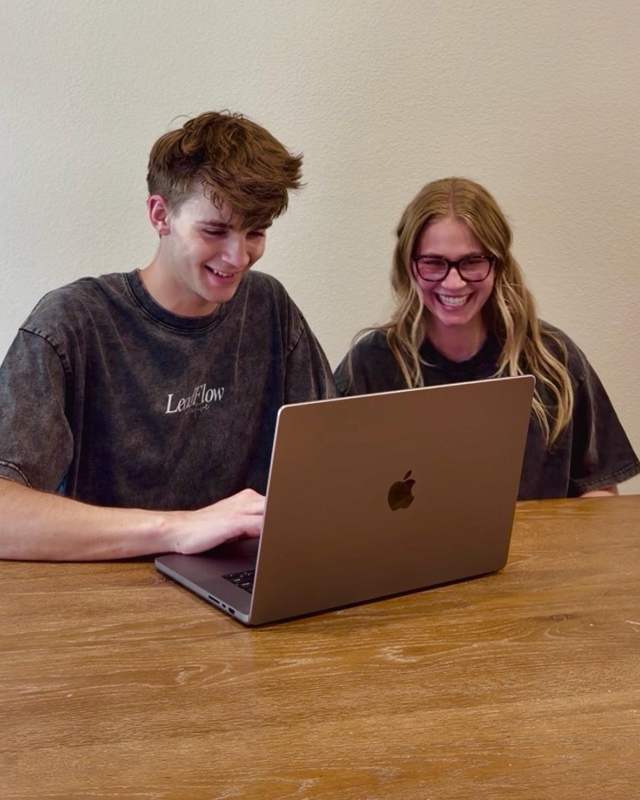 Gage and Grace building a website together on a laptop
